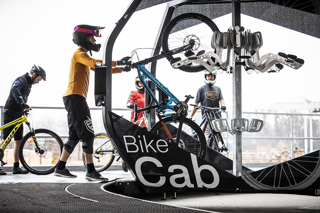 Mountainbike-Fahrer nutzt den Fahrradtransport "Bike Cab" einer Seilbahn von Doppelmayr